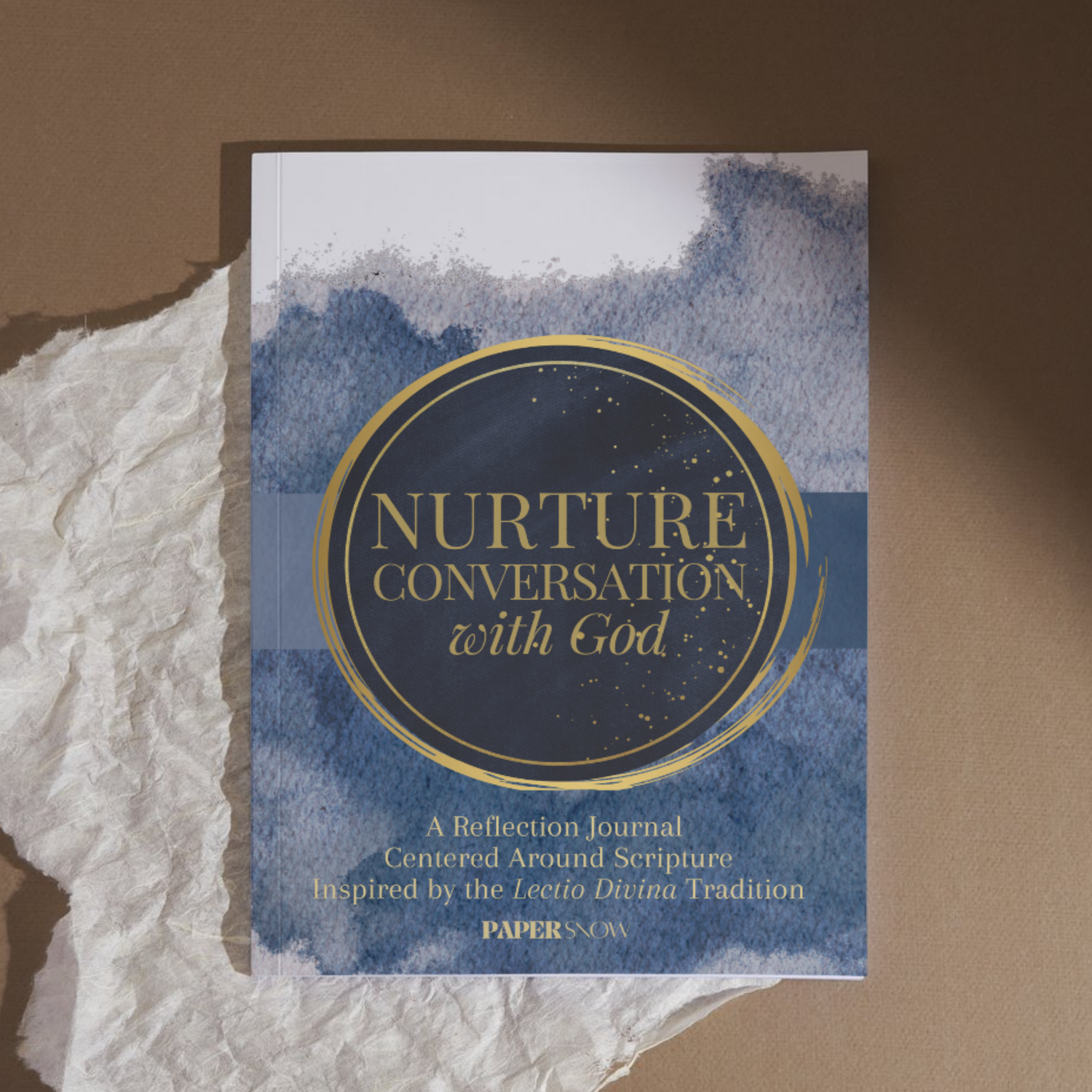 a book and journal sitting on a desk with a sheet paper that helps people read the bible using lectio divina